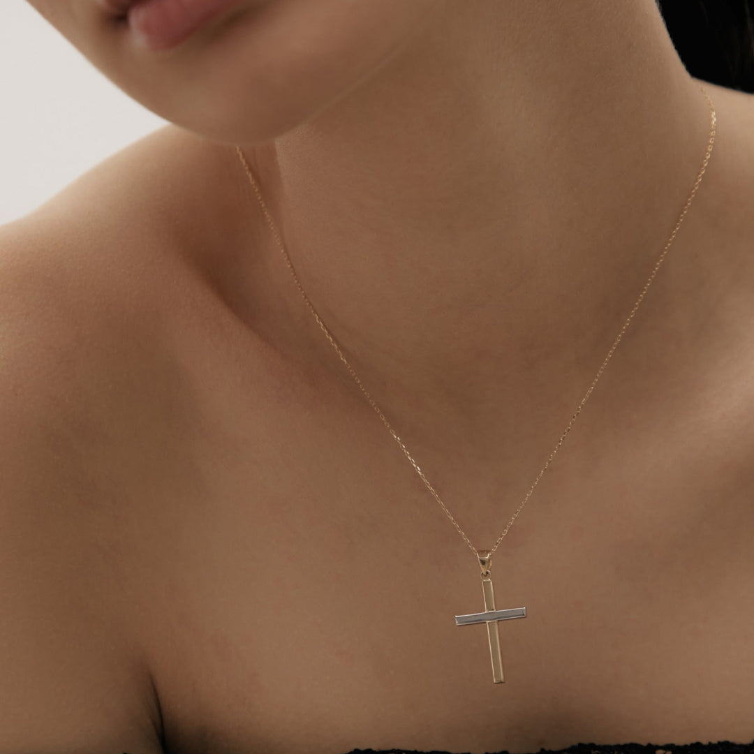Cross-shaped pendant in yellow and white gold