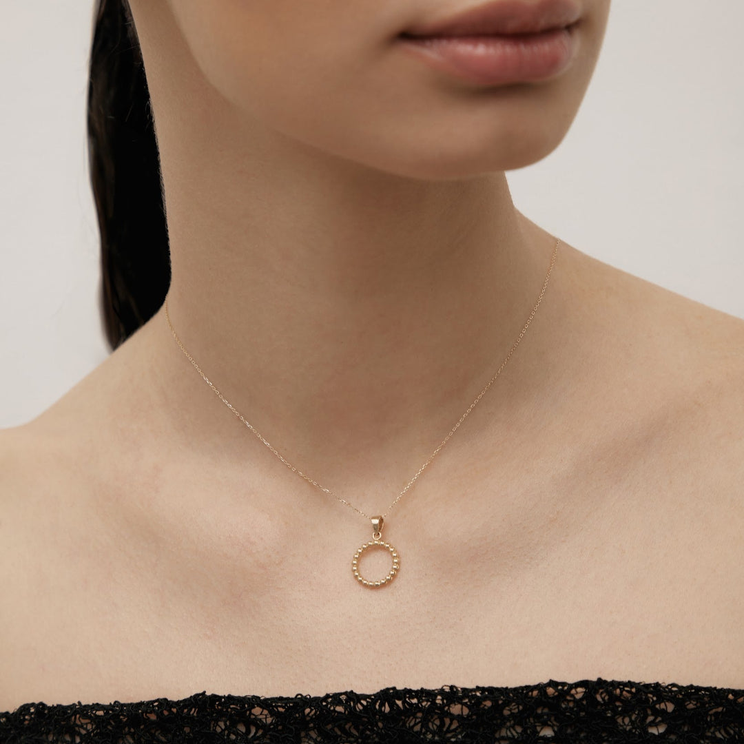 Yellow gold ring-shaped pendant
