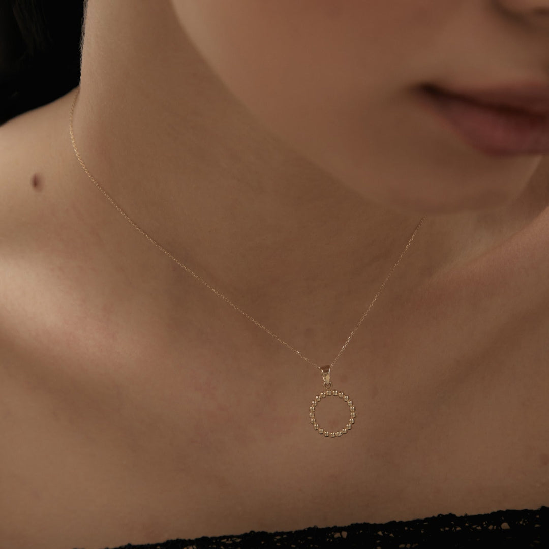 Yellow gold ring-shaped pendant